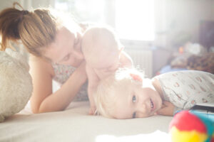 Loving mother playing with her children.