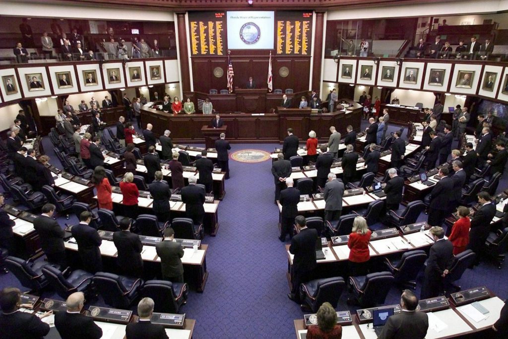 Members of the Florida House bow their heads in pr